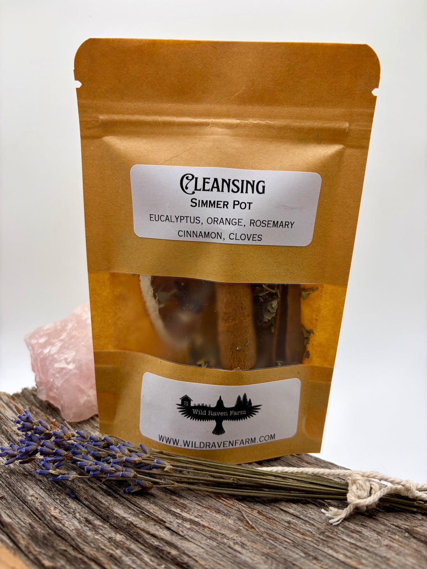 Package of 'Cleansing Simmer Pot' with ingredients listed on a wooden surface.