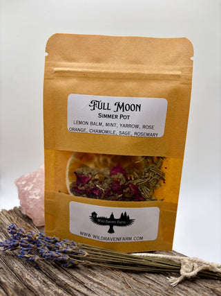 Full Moon simmer pot package with dried herbs on a wooden surface
