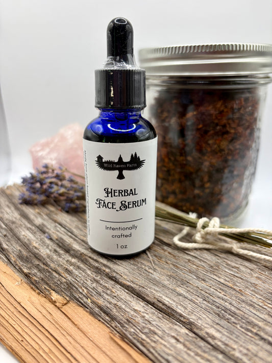 Bottle of herbal face serum on a wooden surface with a jar and lavender in the background.
