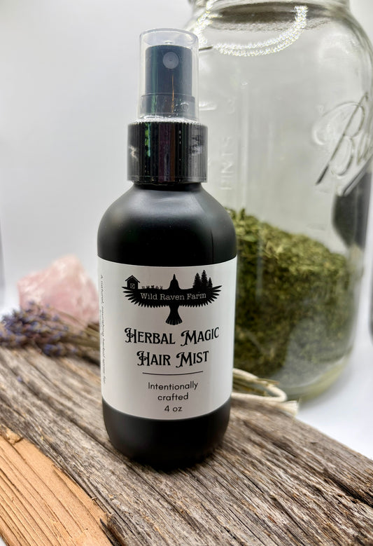 Herbal Magic Hair Mist bottle with a jar of herbs in the background