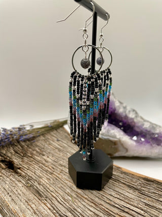 Beaded earrings on a stand with a natural background