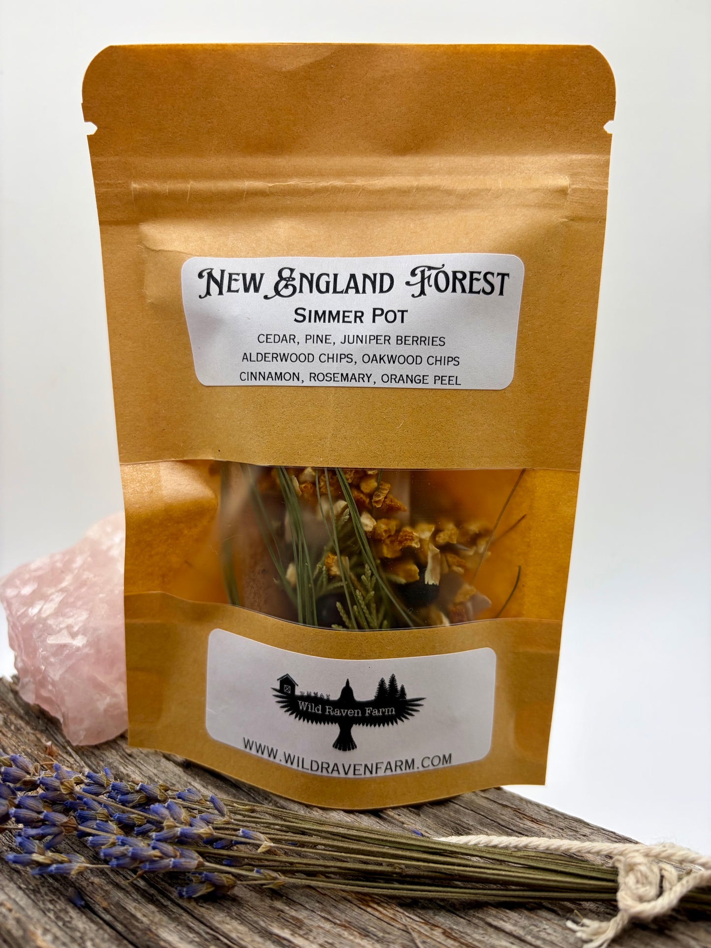 Packaged New England Forest simmer pot with dried herbs on a wooden surface.