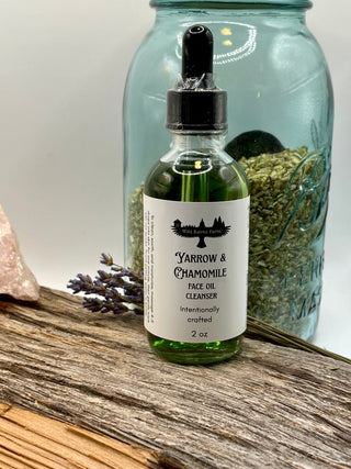 Bottle of Yarrow & Chamomile face oil cleanser with a dropper on a wooden surface.
