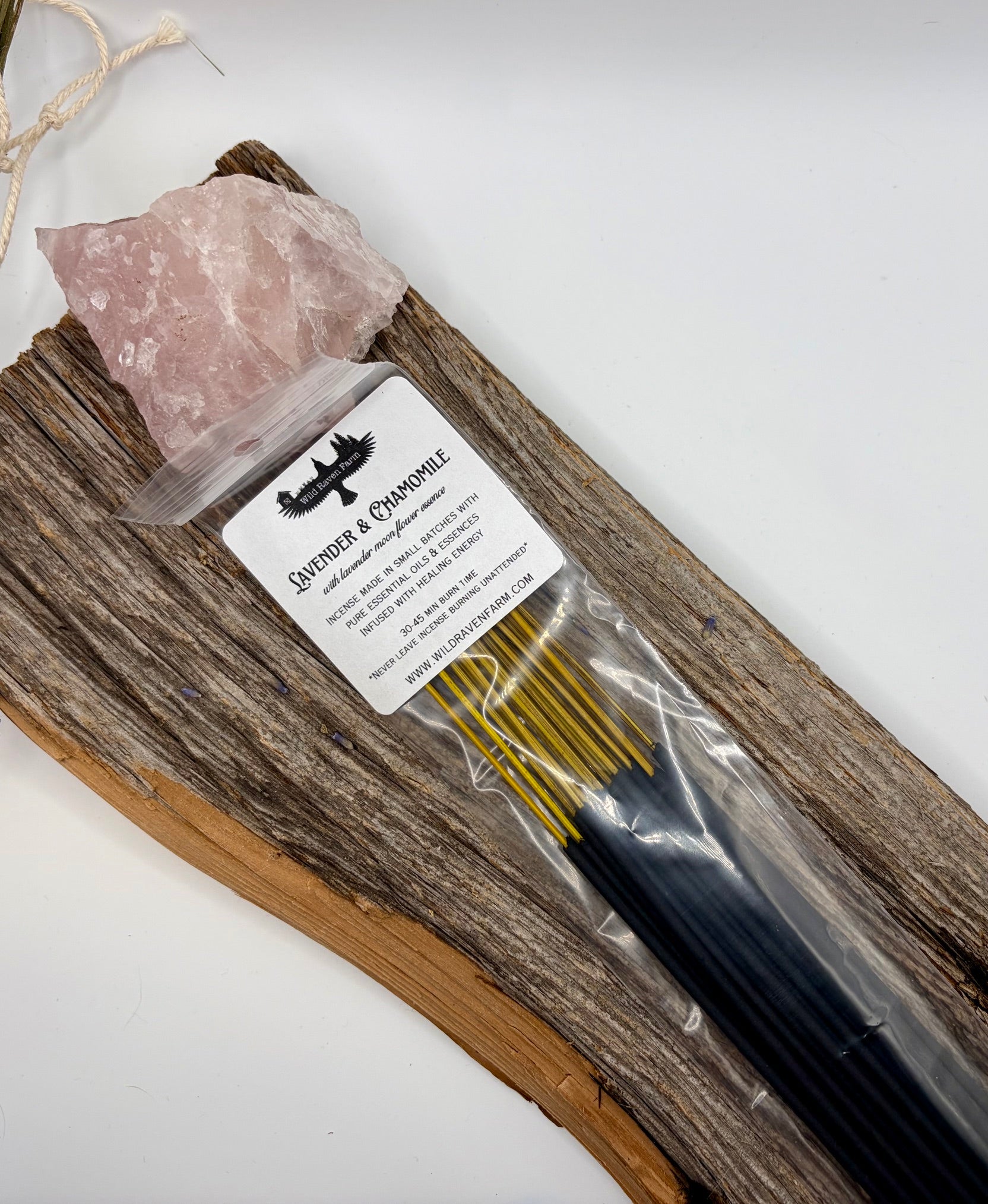 Incense sticks with a label on a wooden board with a crystal