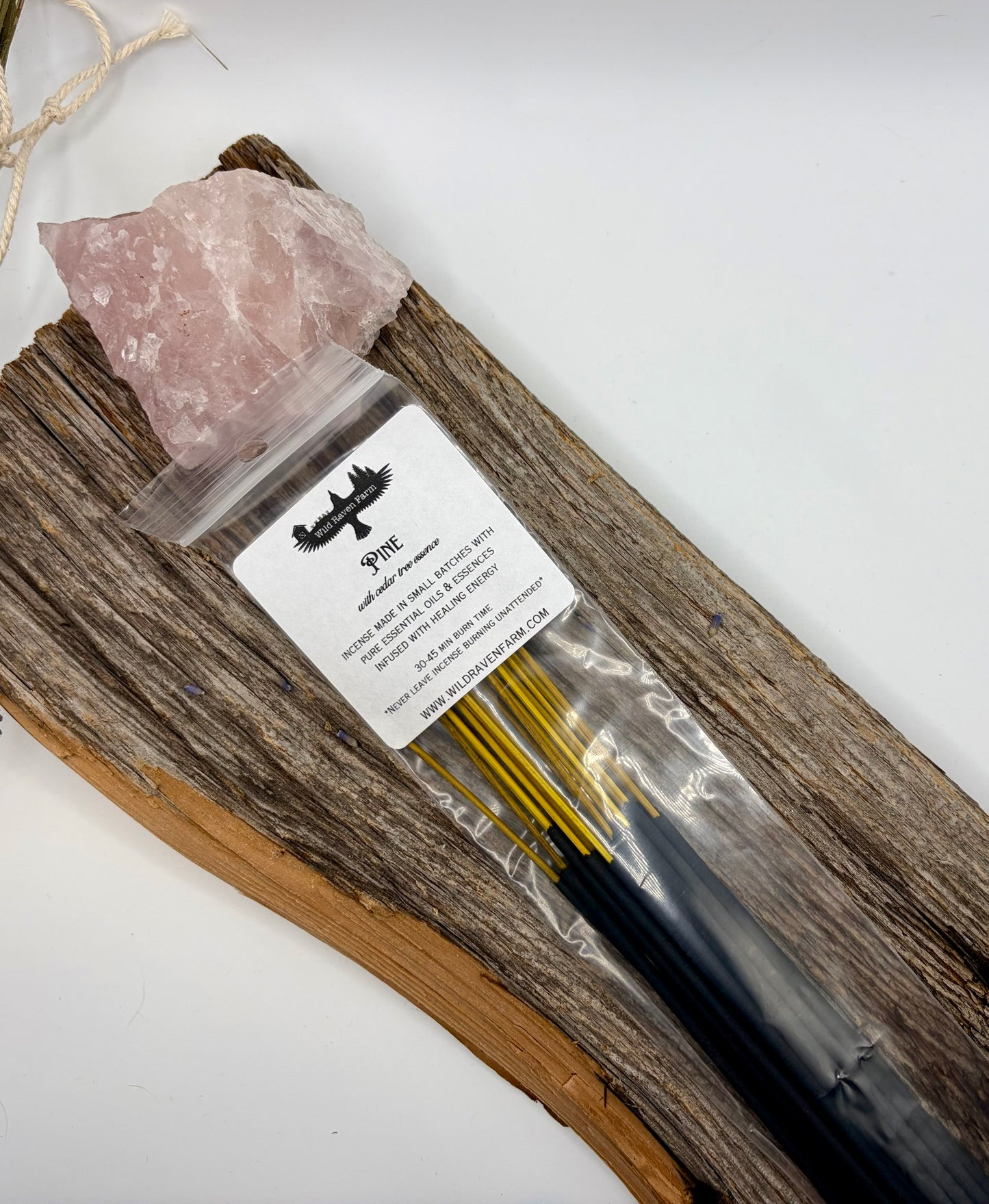 Incense sticks in a bag with a rock and label on a white background