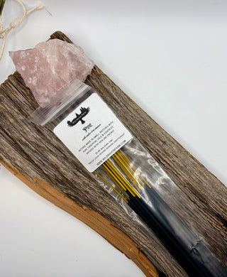 Incense sticks in a bag with a rock and label on a white background